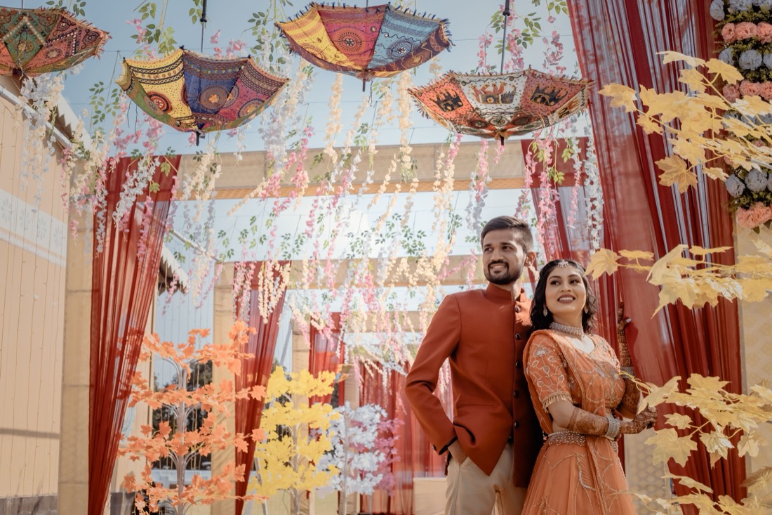 Mehendi entrance decor with hanging umbrellas and floral streamers by SGR Decorators