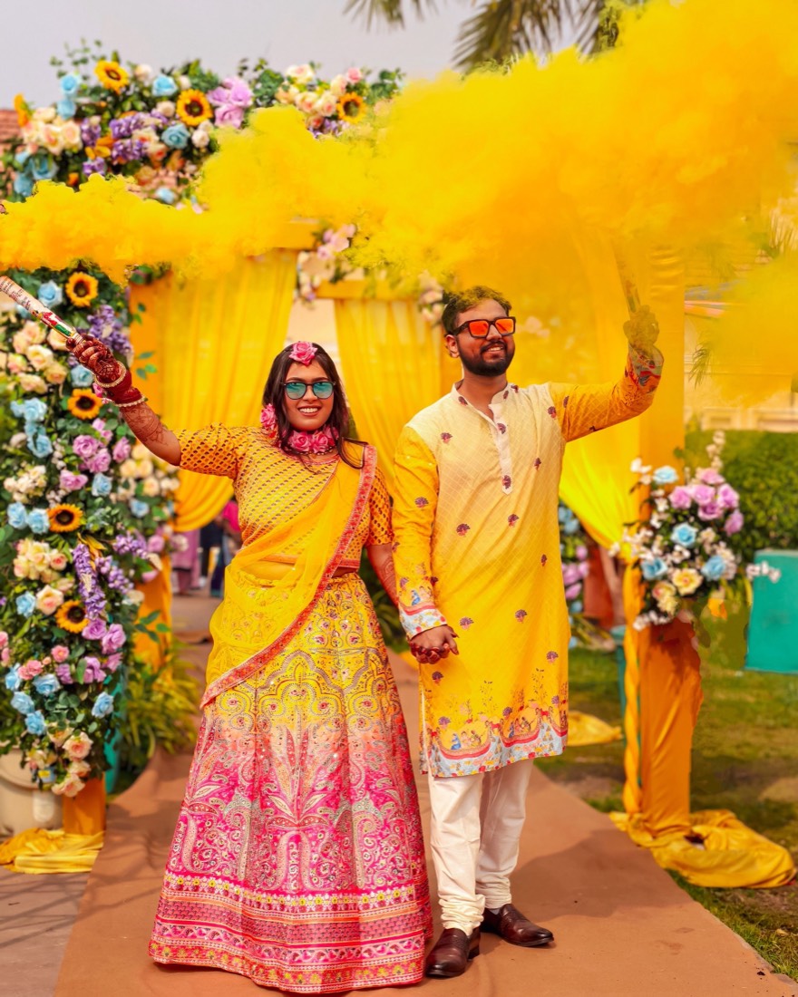 Couple at a vibrant haldi ceremony styled by SGR Decorators