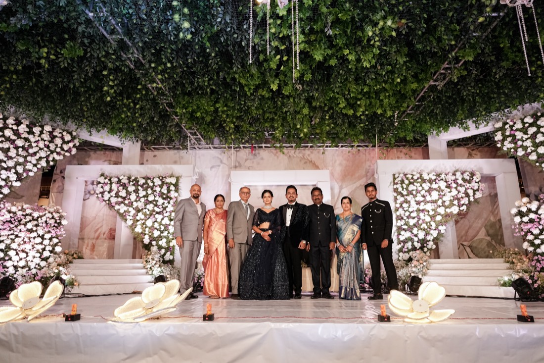 Floral wedding stage with hanging greenery and marigold garlands by SGR Decorators